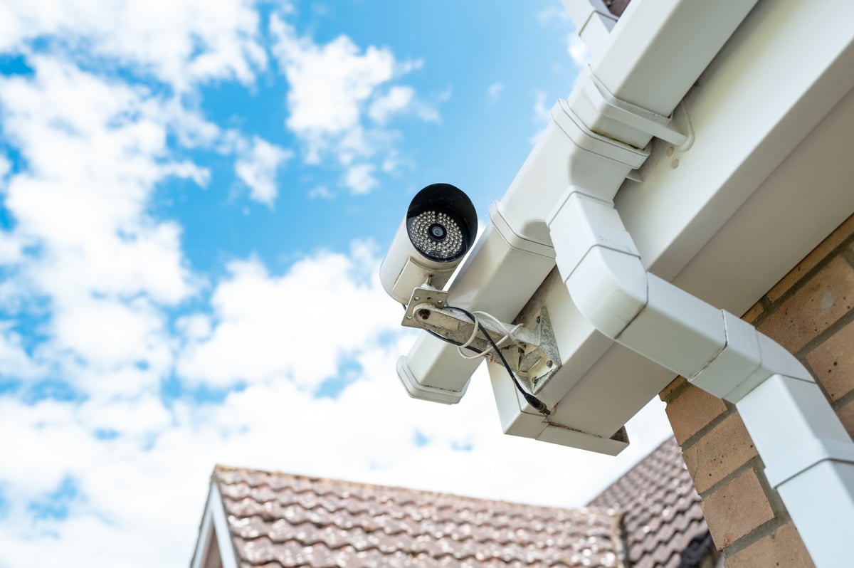 Installed IP security camera mounted on a building exterior with its cabling